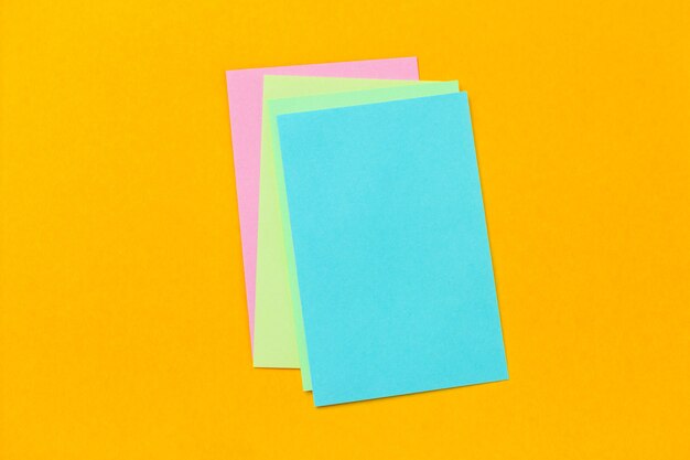 Stack of colored stickers on a vivid yellow background