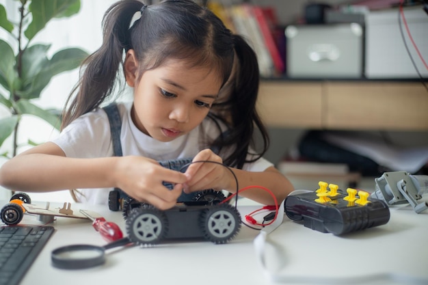 stem education concept asian young girl learning robot design