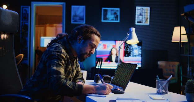 Stockholder looking at market shares growth writing on notepad