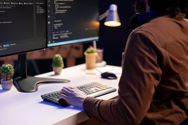 System administrator doing software debugging on PC at home typing on keyboard