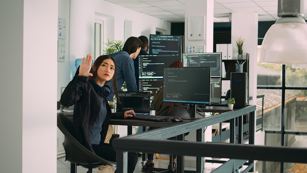 System engineer looking at server ar hologram, using firewall security to develop new interface on terminal window. Working with augmented reality to create software app, cloud computing.