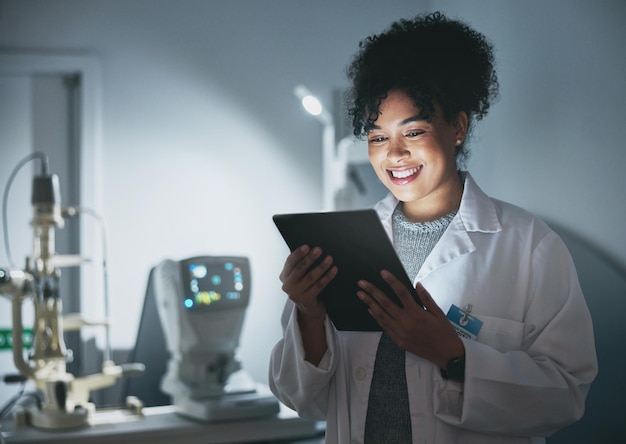 tablet medical doctor and black woman in hospital for online consultation research or telehealth at night healthcare clinic technology and happy female physician with touchscreen for wellness app