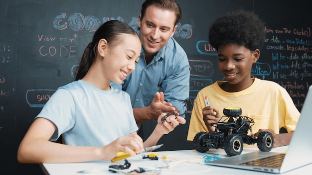 Teacher looking at laptop screen while explain car model system Edification