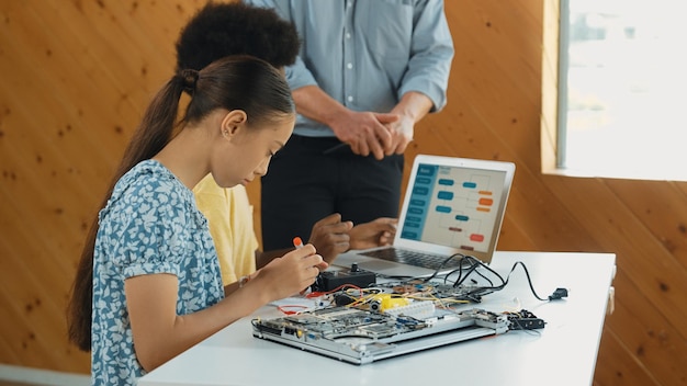 teacher standing while explain coding and robotic construction edification