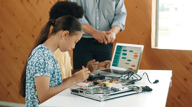 teacher standing while explain coding and robotic construction edification