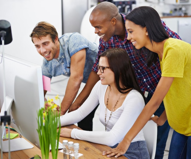 Team diversity and entrepreneurs with computer meeting and support for project collaboration Designers teamwork and professional creativity with office technology and smile for happy workforce
