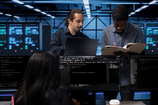 Team leader verifying workers progress in server room