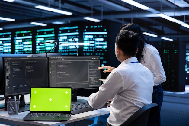 team of technicians in data center using isolated screen laptop
