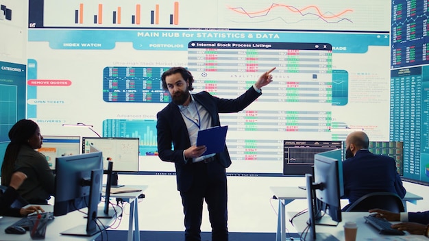 Teammates and manager assembling in a big data room to go over their results