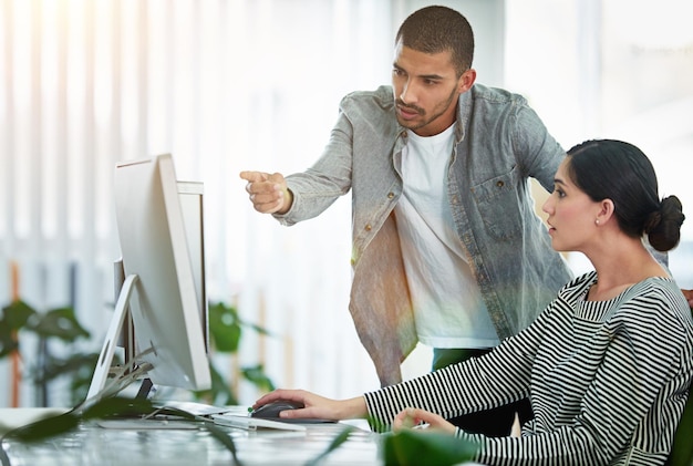 Teamwork computer and business people with training in office for help feedback or review project at desk Company packaging designer and employees for advice coaching or ideas at printing agency