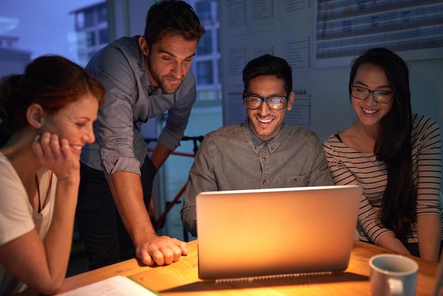 teamwork night and a business group on a laptop working in the boardroom for planning strategy or innovation meeting collaboration and overtime with a team of employees at work in the evening