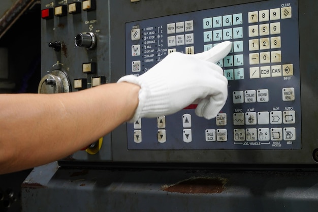 Technician adjusting the program of a cnc machinePlastic and metal forming processes in industrial plants