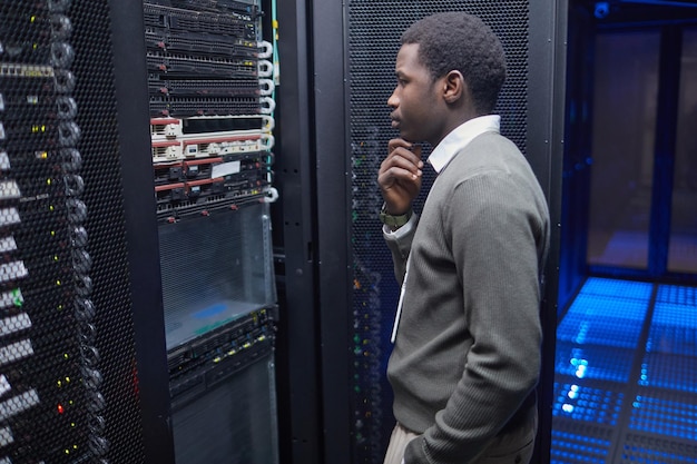 Technician monitoring server performance in data center
