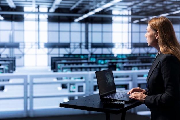 Technician programming in AI server farm housing advanced equipment