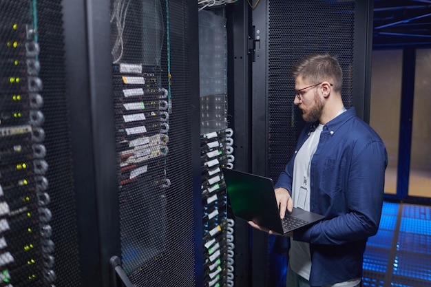 Technician Working in Data Center Monitoring Equipment