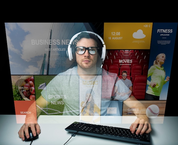 technology, communication, mass media, virtual reality and people concept - young man in headset and eyeglasses with pc computer keyboard over virtual screen