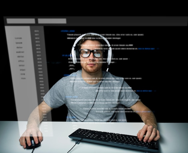 technology, cyberspace, virtual reality and people concept - man or hacker in headset and eyeglasses with keyboard hacking computer system or programming over vitual screen projection