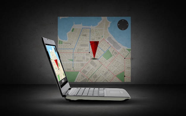 technology, navigation, location and advertisement concept - laptop computer with gps navigator map on screen