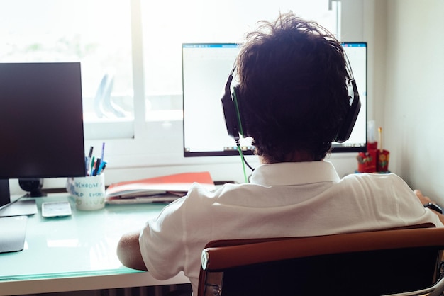Teenager is studying at home attending online classes during the coronavirus covid-19 pandemic