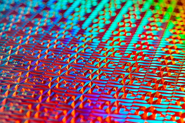 Tekstur af rød folie med holografisk effekt baggrund
