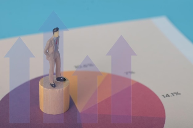 The businessman standing with a focused gaze is analyzing the graph to assess the current economic situation and its impact on his companys strategy