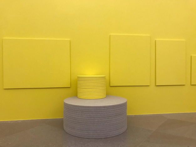 Tiles stacked by yellow wall