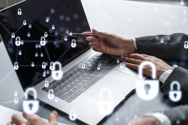 Two business people working on the project to protect cyber security of international company using laptop Padlock Hologram icons Teamwork concept