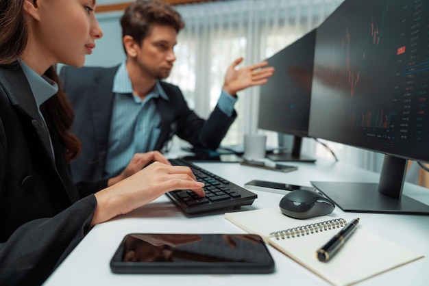 Two business traders in stock woman checking to compare real time Postulate