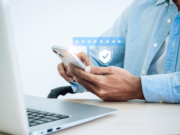 Two factor authentication concept Virtual safety shield icon while access on phone with laptop for validate password Identity verification cybersecurity with biometrics authentication technology