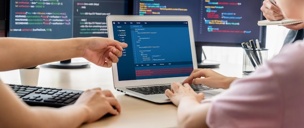 Two smart computer engineers working together to solve program code Burgeoning