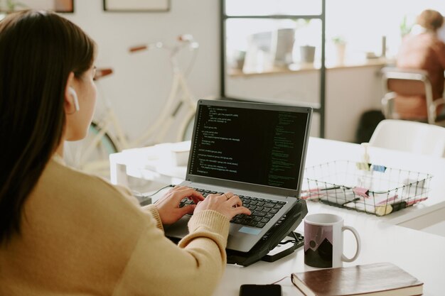 Unrecognizable IT Specialist Programming in Office
