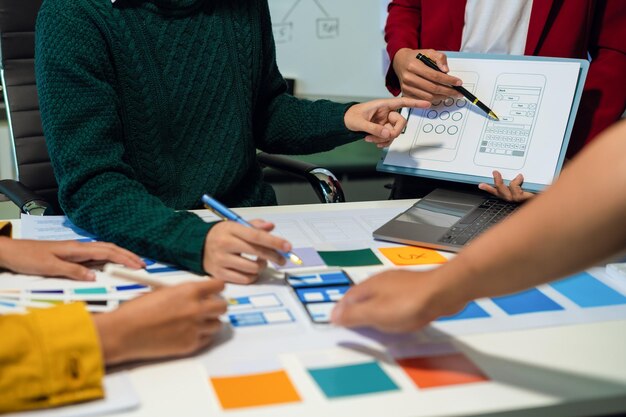UX developer and ui designer brainstorming about mobile app interface wireframe design with customer breif and color code User experience concept