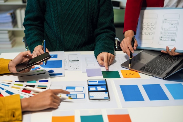 UX developer and ui designer brainstorming about mobile app interface wireframe design with customer breif and color code User experience concept