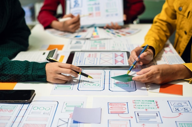 UX developer and ui designer brainstorming about mobile app interface wireframe design with customer breif and color code User experience concept