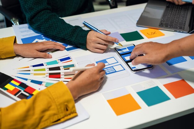 UX developer and ui designer brainstorming about mobile app interface wireframe design with customer breif and color code User experience concept
