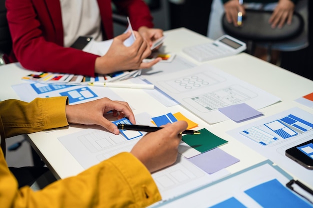 UX developer and ui designer brainstorming about mobile app interface wireframe design with customer breif and color code User experience concept