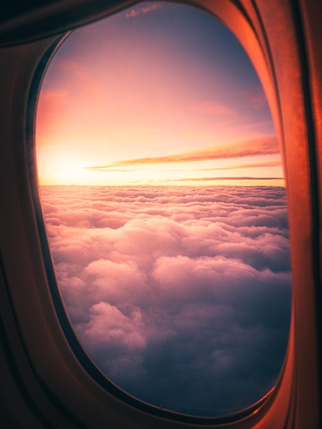 View of cloudy sky seen through airplane window