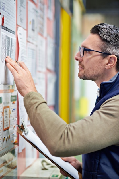 Warehouse employee and man with clipboard board and industry of shipping and manufacturing Checklist staff and male person with inventory for goods or stock in factory job and logistics