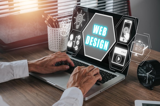 web design concept person working on laptop computer with web design icon on virtual screen