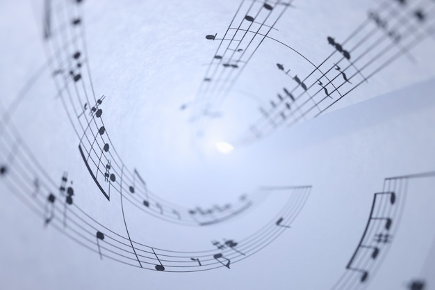 White paper with musical notes rolled up closeup background music writing concept