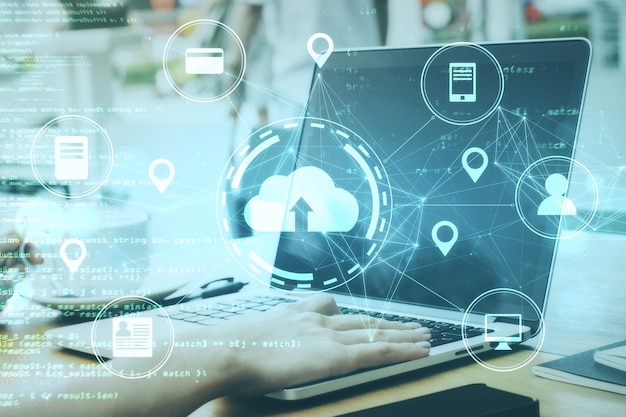 Woman hands using laptop with online shopping and networking cloud diagram
