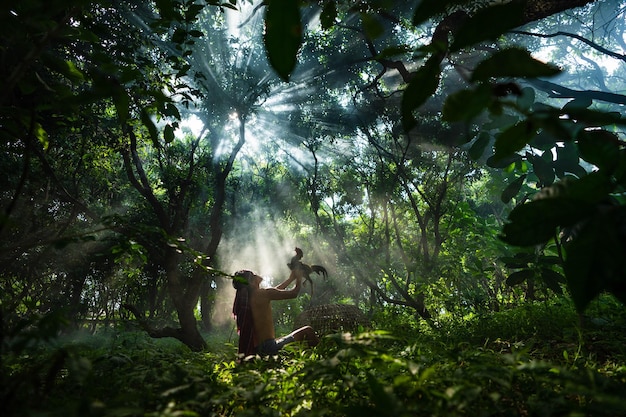 woman in sunlight falling on trees in forest