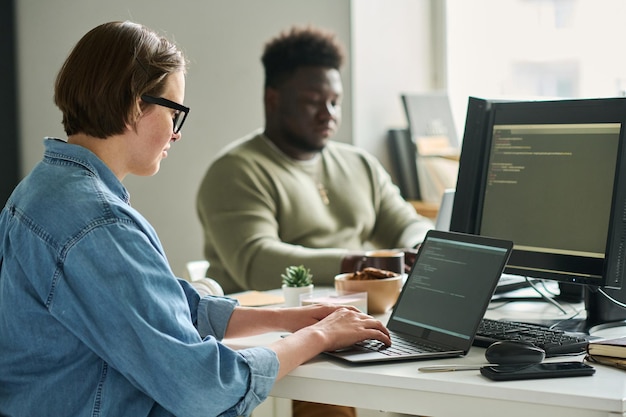 Woman working on laptop at IT company