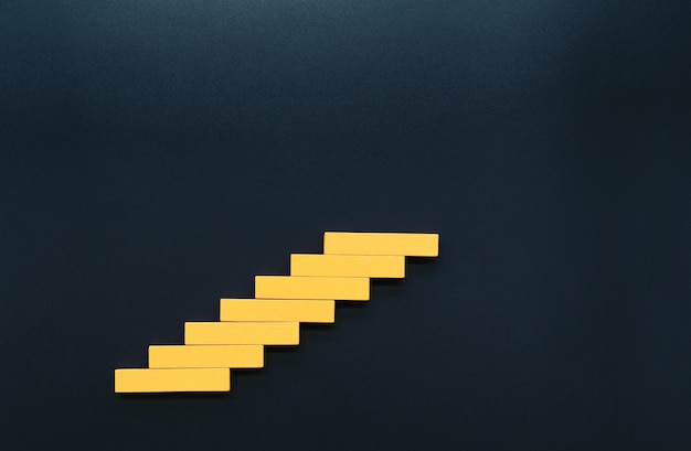 Wooden block stacking as step staircase. Business concept for growth successful