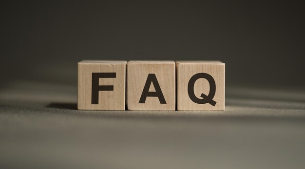 Word FAQ made with wood building blocks on a gray background