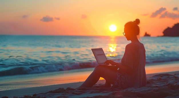 working on laptop at sunset beach