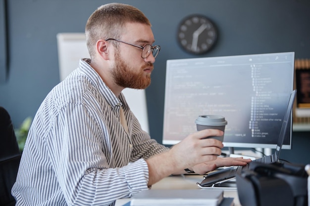 Working Professional Coding on Computer in Office