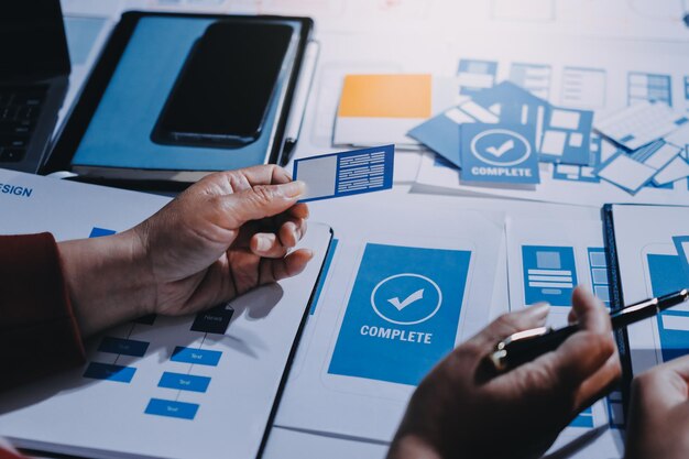 young asian business creative team work together mobile application software design project brainstorm meeting internet technology smartphone web app designer office coworker teamwork concept