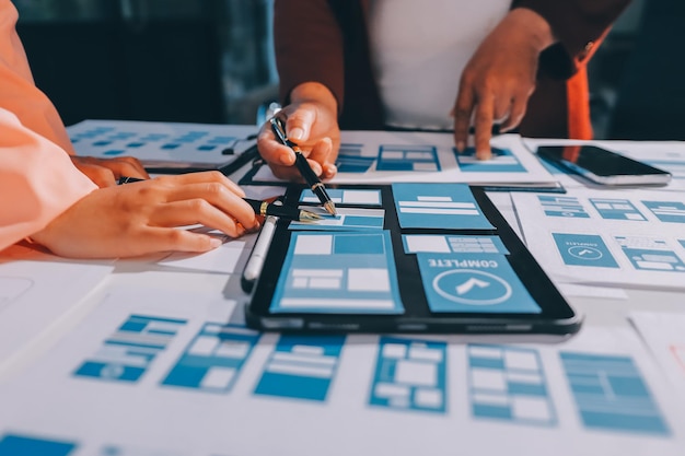 young asian business creative team work together mobile application software design project brainstorm meeting internet technology smartphone web app designer office coworker teamwork concept