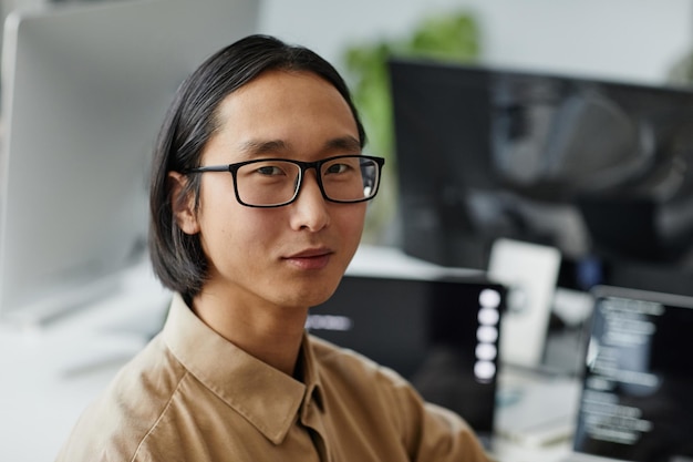 Young Asian businessman in eyeglasses and formal shirt